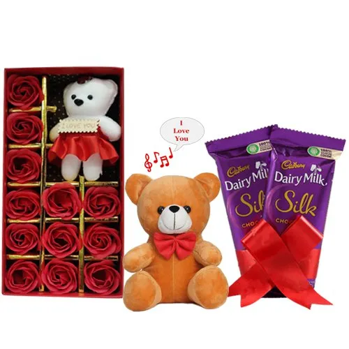 Spectacular Teddy on Artificial Red Roses with Chocolate N Singing Soft Toy Combo
