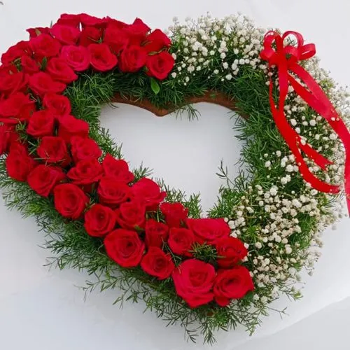 Amusing Heart Shaped Arrangement of Red Roses with white Baby Breath fillers