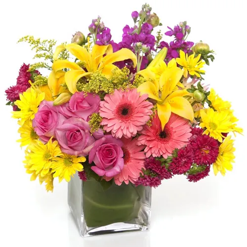 Radiant Arrangement of Mixed Seasonal Flowers in a Glass Vase