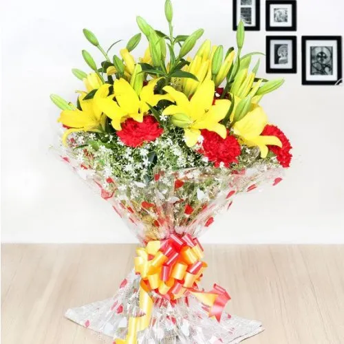 Marvelous Red Carnations with Yellow Lilies Hand Bunch
