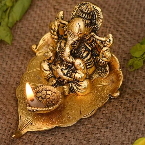 Remarkable Ganesha on Leaf with Diya